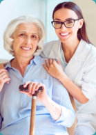 caregiver and elderly woman both smiling