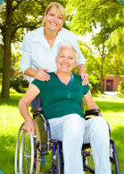disabled senior woman in wheelchair with her caregiver